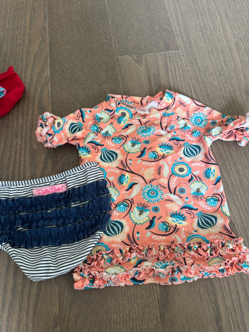 Ruffle Butts Coral Floral Rash Guard Set with Navy Striped Ruffle Bottoms